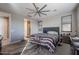 Spacious main bedroom with a fan and access to the bathroom at 7735 W Agora Ln, Phoenix, AZ 85043