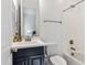 Bright bathroom features a vanity with storage, framed mirror, and a shower and bathtub combination at 8804 W Vista Ave, Glendale, AZ 85305
