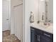 Bathroom featuring dark vanity, shower with curtain, and bright lighting at 8804 W Vista Ave, Glendale, AZ 85305