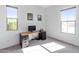 Carpeted bedroom featuring natural light, neutral walls, and desk space at 8804 W Vista Ave, Glendale, AZ 85305
