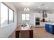 Dining area with large windows providing plenty of natural light and wood dining table with seating at 8804 W Vista Ave, Glendale, AZ 85305