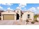 Charming single-story home featuring a brown garage door, arched entryway, and low-maintenance front yard at 8804 W Vista Ave, Glendale, AZ 85305