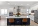 Modern kitchen featuring white cabinetry, stainless steel appliances, and an island with bar seating at 8804 W Vista Ave, Glendale, AZ 85305