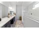 Clean and spacious main bathroom with marble floors, long vanity, and glass enclosed shower at 8804 W Vista Ave, Glendale, AZ 85305