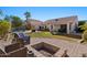 Spacious backyard complete with a patio, pool and raised brick fire pit. A great entertaining space at 9826 E Irwin Cir, Mesa, AZ 85209