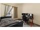 This bedroom includes a bed, window, desk and chair, and is well-suited for a gamer at 9826 E Irwin Cir, Mesa, AZ 85209