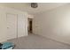 A bright, empty bedroom with carpeted floors, a ceiling fan, and a double-door closet at 9826 E Irwin Cir, Mesa, AZ 85209
