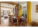 Inviting dining room with rustic chandelier and views of the living area at 9826 E Irwin Cir, Mesa, AZ 85209