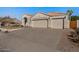 Spacious three-car garage and driveway offers ample parking with mature landscaping at 9826 E Irwin Cir, Mesa, AZ 85209