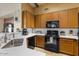 This well-lit kitchen includes updated stainless steel appliances and stone countertops at 9826 E Irwin Cir, Mesa, AZ 85209