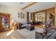 Cozy living room featuring wood-beamed ceilings and an arched entryway to dining area at 9826 E Irwin Cir, Mesa, AZ 85209