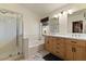 Well-lit bathroom featuring double sinks, modern cabinetry, a walk-in shower, and separate tub at 9826 E Irwin Cir, Mesa, AZ 85209