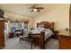 Comfortable main bedroom featuring a large bed, dark wood furniture, and a picturesque view of the backyard at 9826 E Irwin Cir, Mesa, AZ 85209