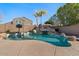 Sparkling pool featuring rock waterfall, sport court, and desert landscaping creates a backyard oasis at 9826 E Irwin Cir, Mesa, AZ 85209