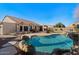 View of the pool and backyard with hot tub, landscaping, and outdoor seating for relaxation and enjoyment at 9826 E Irwin Cir, Mesa, AZ 85209