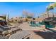 Outdoor pool area featuring lounge chairs, hot tub, and waterfall providing relaxation and recreation at 9826 E Irwin Cir, Mesa, AZ 85209