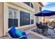 Outdoor patio area with a blue umbrella, chairs, and privacy provided by a block wall at 10203 N 12Th Pl # 3, Phoenix, AZ 85020