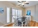 Dining room with wood floors, plantation shutters, a modern table, and stylish decor at 10203 N 12Th Pl # 3, Phoenix, AZ 85020