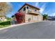 Two-story home featuring a balcony, stucco walls, red bougainvillea bush, and mountain views at 10203 N 12Th Pl # 3, Phoenix, AZ 85020