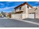 View of the home's stucco exterior, balcony, garage, and manicured landscaping at 10203 N 12Th Pl # 3, Phoenix, AZ 85020