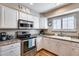 Kitchen showcasing granite countertops, stainless steel appliances, and white cabinetry at 10203 N 12Th Pl # 3, Phoenix, AZ 85020