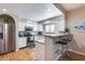 Bright kitchen featuring stainless steel appliances, white cabinets, and a breakfast bar at 10203 N 12Th Pl # 3, Phoenix, AZ 85020