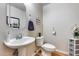 Bright powder room featuring a pedestal sink, decorative mirror, and charming nautical decor at 10203 N 12Th Pl # 3, Phoenix, AZ 85020