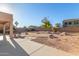 Well-maintained backyard with desert landscaping, paved patio area, and privacy wall at 10318 E Irwin Ave, Mesa, AZ 85209