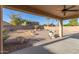 Spacious covered patio overlooking a backyard with desert landscaping and block wall at 10318 E Irwin Ave, Mesa, AZ 85209