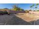 Spacious backyard with desert landscaping, paved patio area, and privacy wall at 10318 E Irwin Ave, Mesa, AZ 85209