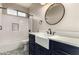 Charming bathroom featuring farmhouse sink, custom navy blue cabinets, and tiled shower at 10318 E Irwin Ave, Mesa, AZ 85209