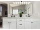 Bathroom with double vanity sinks, granite counters, and black hardware at 10318 E Irwin Ave, Mesa, AZ 85209