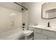 Bright bathroom with white tile shower, toilet and vanity at 10318 E Irwin Ave, Mesa, AZ 85209