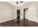 Bedroom featuring a closet, ceiling fan, wood-look floors, and access to an attached desk area at 10318 E Irwin Ave, Mesa, AZ 85209