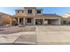 Inviting two-story home featuring a spacious three-car garage and low-maintenance desert landscaping at 10318 E Irwin Ave, Mesa, AZ 85209