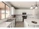 Well-lit kitchen featuring granite counters, stainless steel appliances, and white cabinetry at 10318 E Irwin Ave, Mesa, AZ 85209