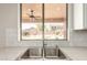 View of the backyard from the kitchen sink, with white tile backsplash and granite counters at 10318 E Irwin Ave, Mesa, AZ 85209