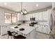 Modern kitchen features an island, stainless steel appliances, and sleek countertops at 10318 E Irwin Ave, Mesa, AZ 85209