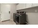 Modern laundry room with cabinets above the side-by-side washer and dryer units at 10318 E Irwin Ave, Mesa, AZ 85209