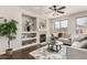 Cozy living room with fireplace, built-in shelves, and a ceiling fan at 10318 E Irwin Ave, Mesa, AZ 85209