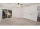 Spacious carpeted bedroom with sliding glass doors leading to the patio at 10419 W Loma Blanca Dr, Sun City, AZ 85351