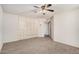Bedroom boasts carpet, built in storage cabinets and drawers, a ceiling fan and ample natural light at 10419 W Loma Blanca Dr, Sun City, AZ 85351