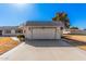 Two car garage with large driveway and well maintained lawn at 10419 W Loma Blanca Dr, Sun City, AZ 85351