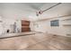 Spacious garage with both a garage door and a side entry door, storage cabinets and a water heater at 10419 W Loma Blanca Dr, Sun City, AZ 85351
