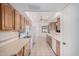 Open-concept kitchen with updated appliances, light wood cabinets, and ample counter space at 10419 W Loma Blanca Dr, Sun City, AZ 85351