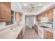 Well-lit kitchen featuring light cabinets, tile countertops, and modern appliances at 10419 W Loma Blanca Dr, Sun City, AZ 85351