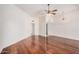 Spacious living room featuring hardwood floors, ceiling fan, and modern lighting fixture at 10419 W Loma Blanca Dr, Sun City, AZ 85351