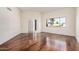 An empty living room with hardwood floors and large window at 10419 W Loma Blanca Dr, Sun City, AZ 85351
