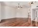 Large open living room with a ceiling fan and hardwood floors at 10419 W Loma Blanca Dr, Sun City, AZ 85351