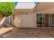 Covered patio with white columns and a travertine tile floor. View of a green tree and siding at 10419 W Loma Blanca Dr, Sun City, AZ 85351